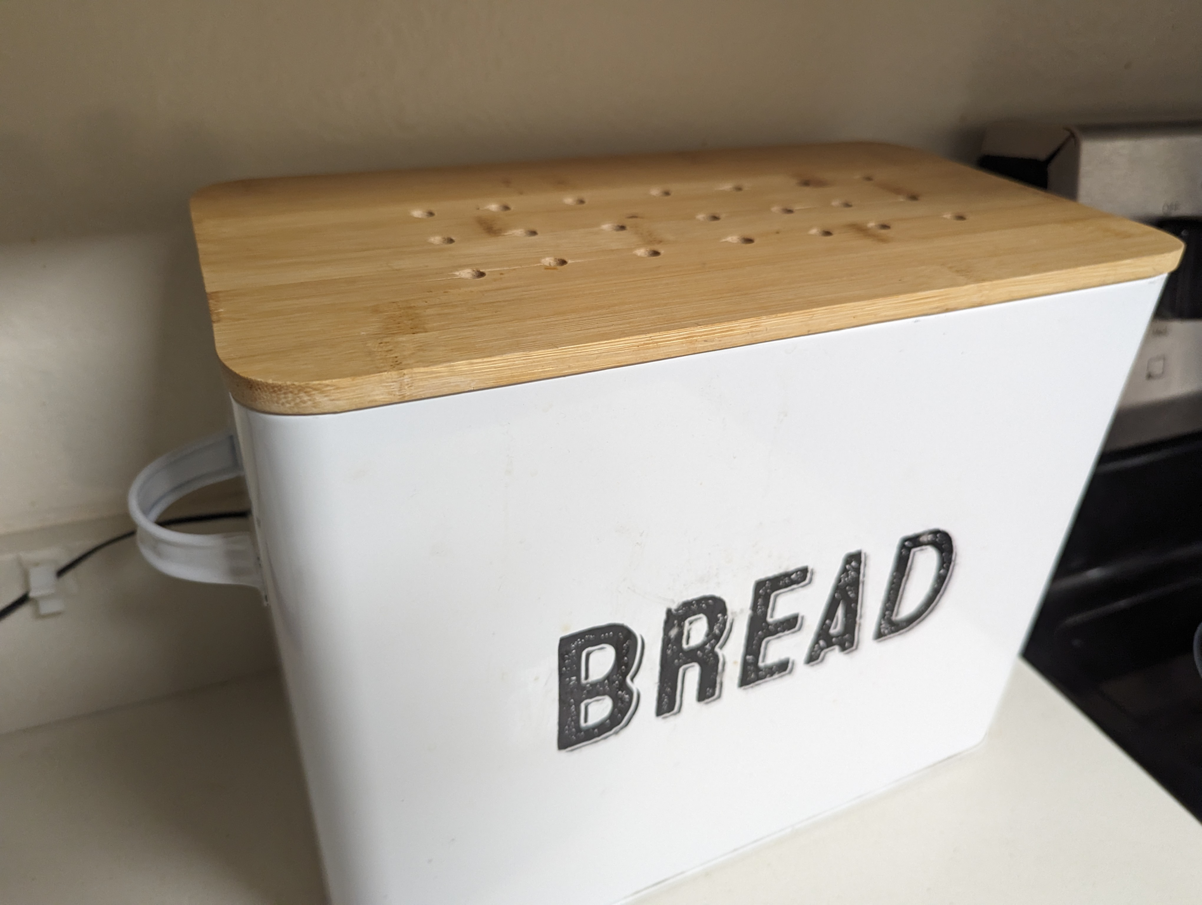 Bread bin showing ventilation holes and fan wire